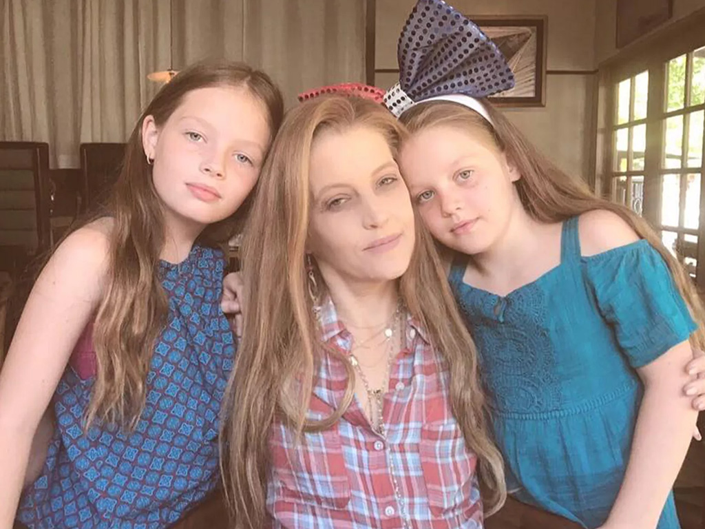 Lisa Marie Presley and her identical twin daughters.