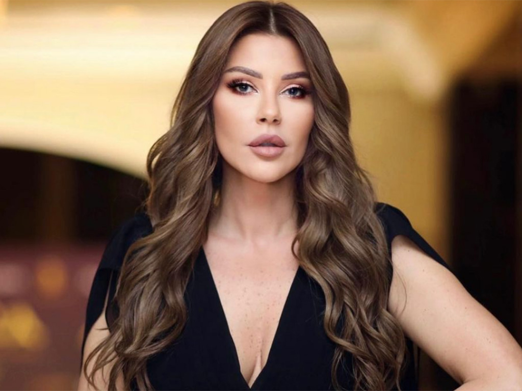 Carla Diab Hadda in a photoshoot with a bold makeup look and wavy hair.