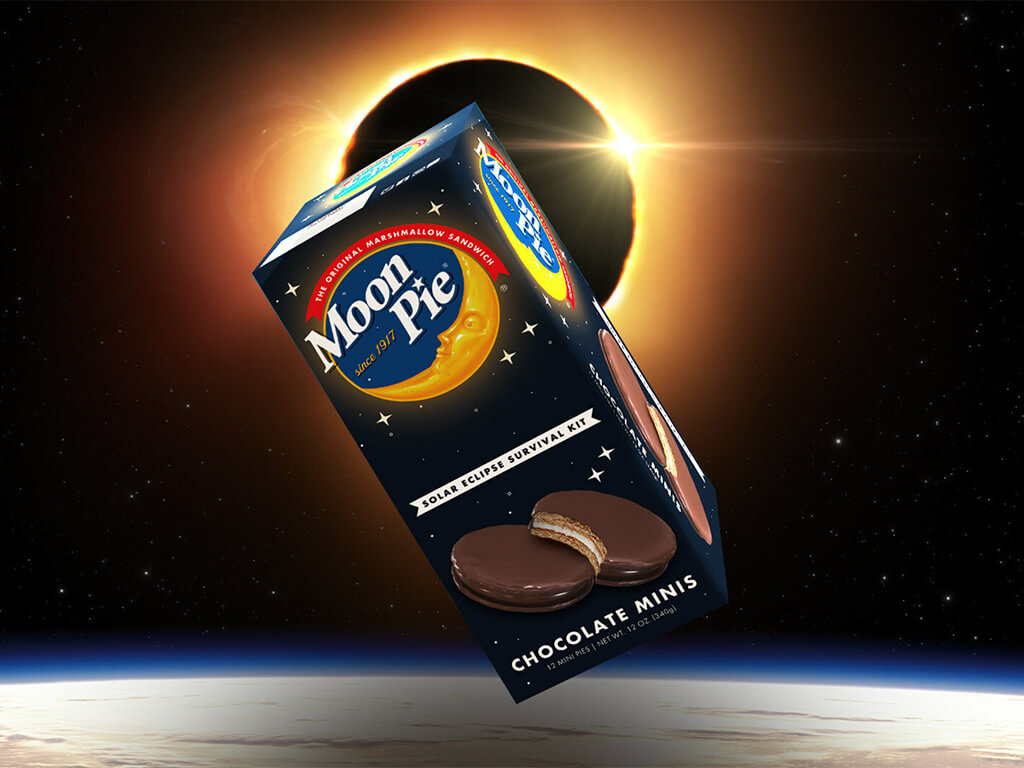 A box of Moon Pie snacks in front of a solar eclipse