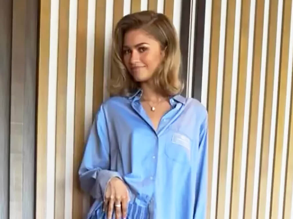 Zendaya in a blue shirt with blonde hair