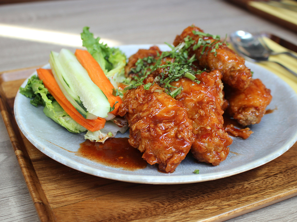 A plate of hot wings and vegetables