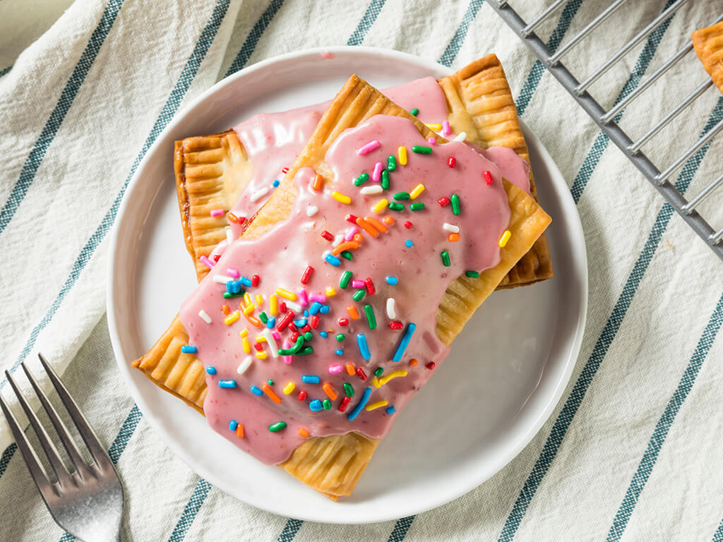 Breakfast pastries with pink icing and sprinkles