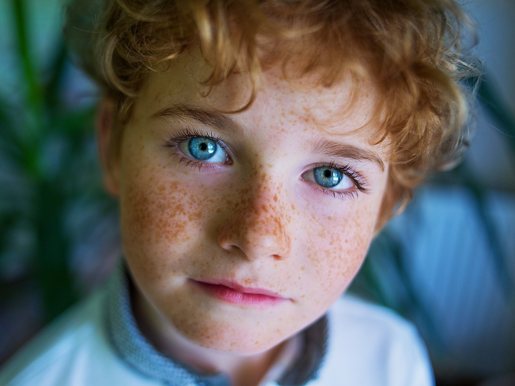 boy's face close-up, freckles face, portrait of blue-eyed boy with freckles close-up
