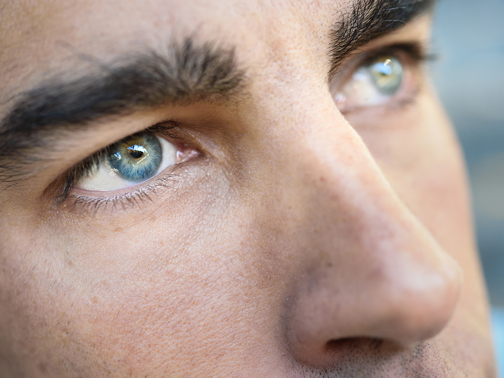 Close-up shot of man's eye. Man with blue eyes.