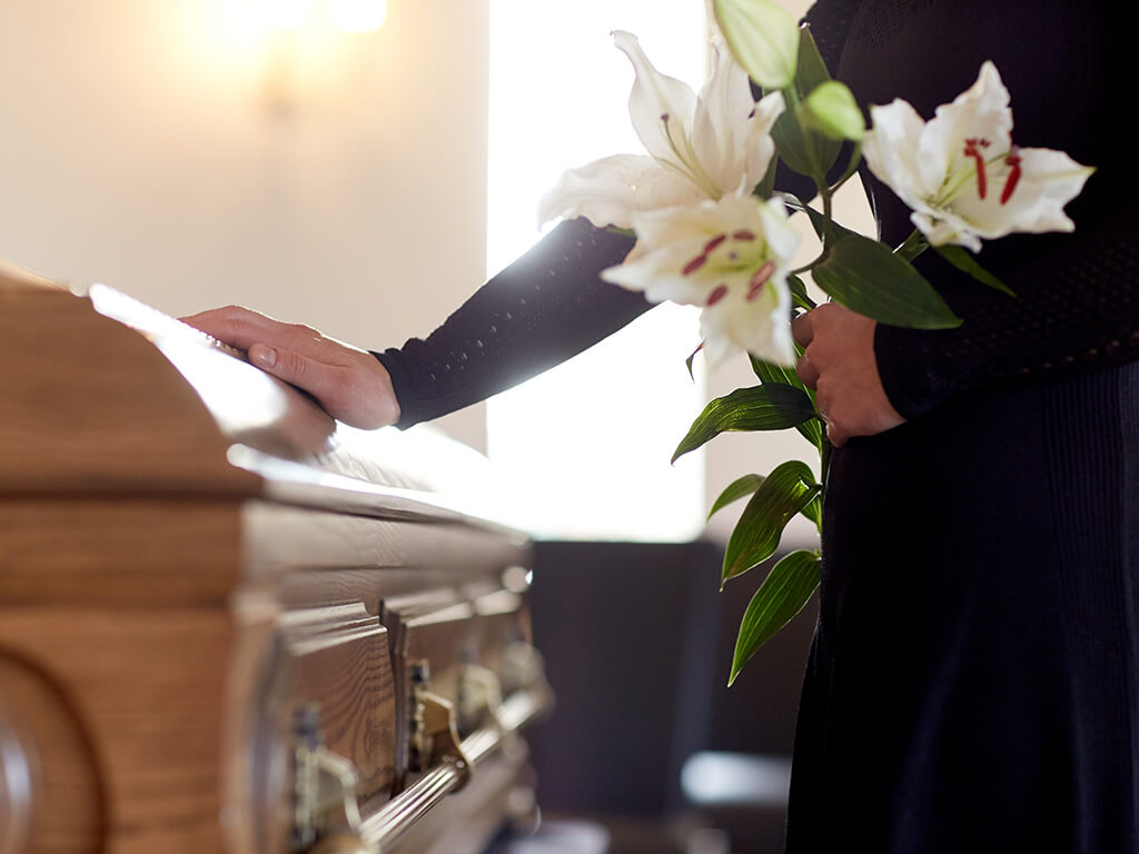 Person holding flowers at funeral