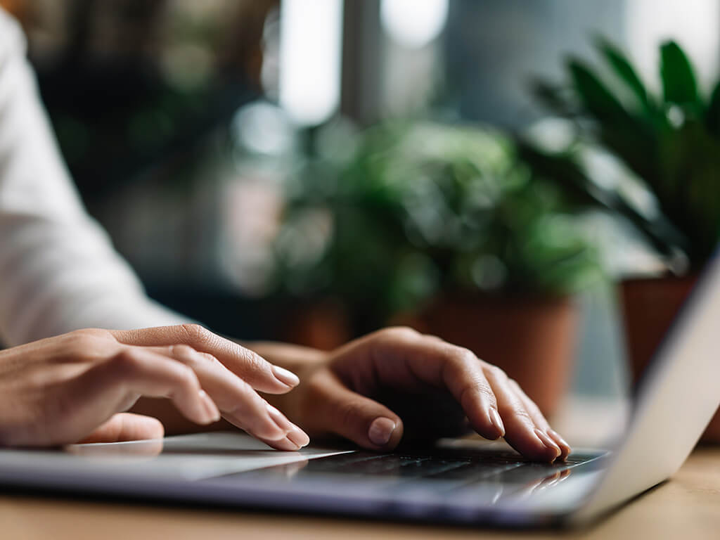 Person typing on keyboard